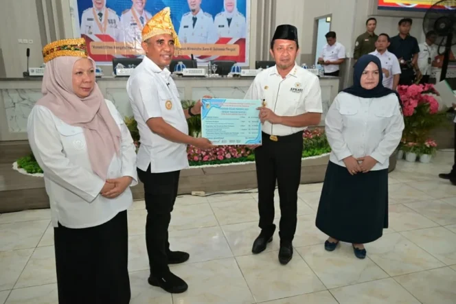 
					Gubernur Sulawesi Tengah, Dr. H. Anwar Hafid, M.Si., serahkan Piagam Penghargaan dari BPJS Ketenagakerjaan atas komitmen Pemprov Sulteng memperluas perlindungan sosial, kepada Bupati Touna, Ilham Lawidu, di Auditorium Kantor Bupati. (Foto: Istimewa)